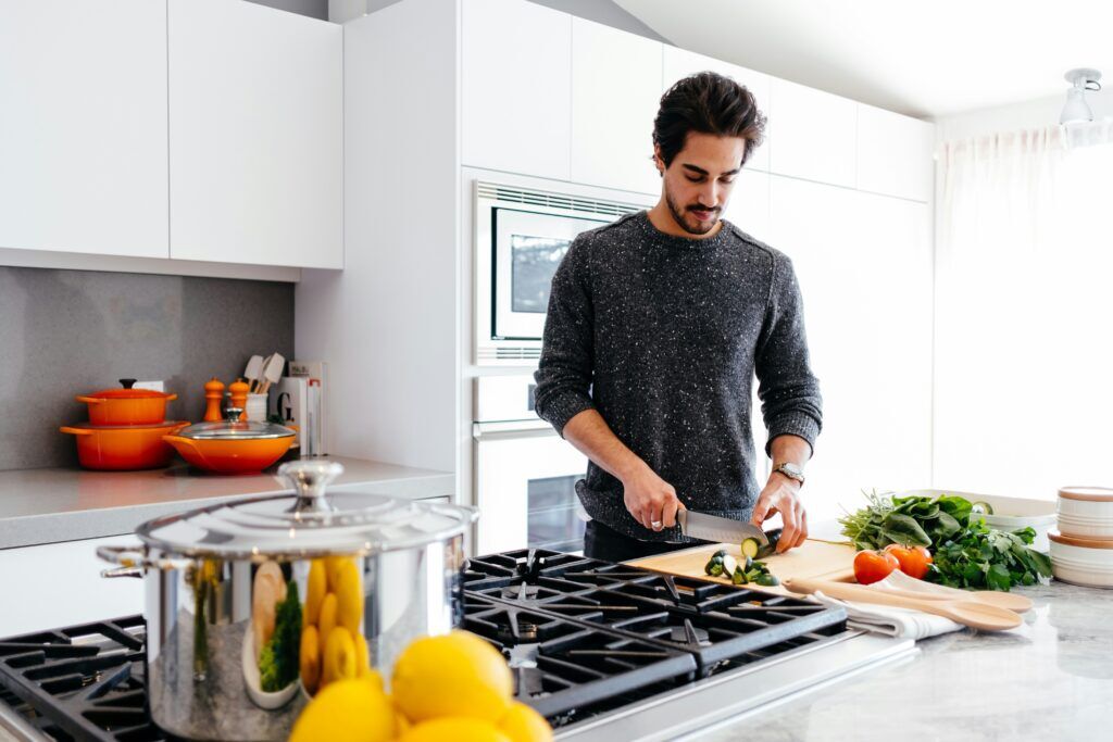 A man cooking in a remodeled kitchen